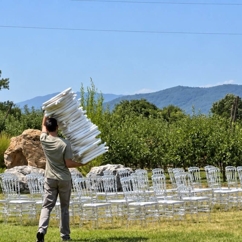 Wedding planner Elina greeting international guests at an outdoor wedding celebration in Tbilisi